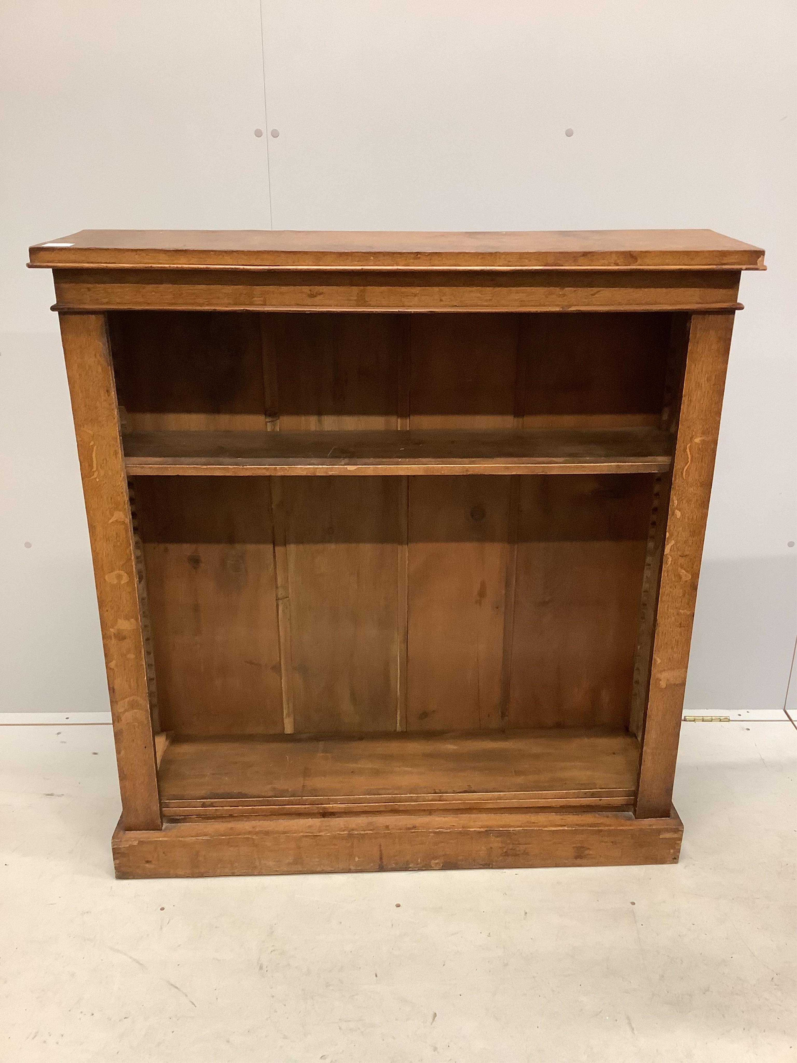 A late Victorian oak open bookcase, width 110cm, depth 28cm, height 117cm. Condition - fair